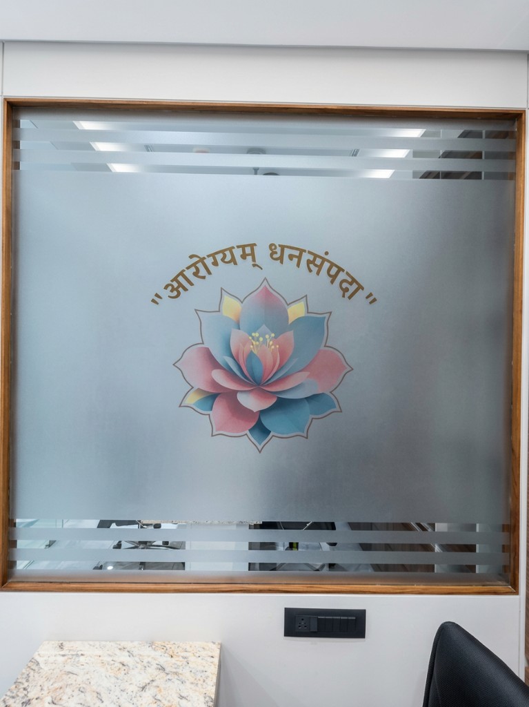 Lotus emblem on a frosted glass partition inside the clinic